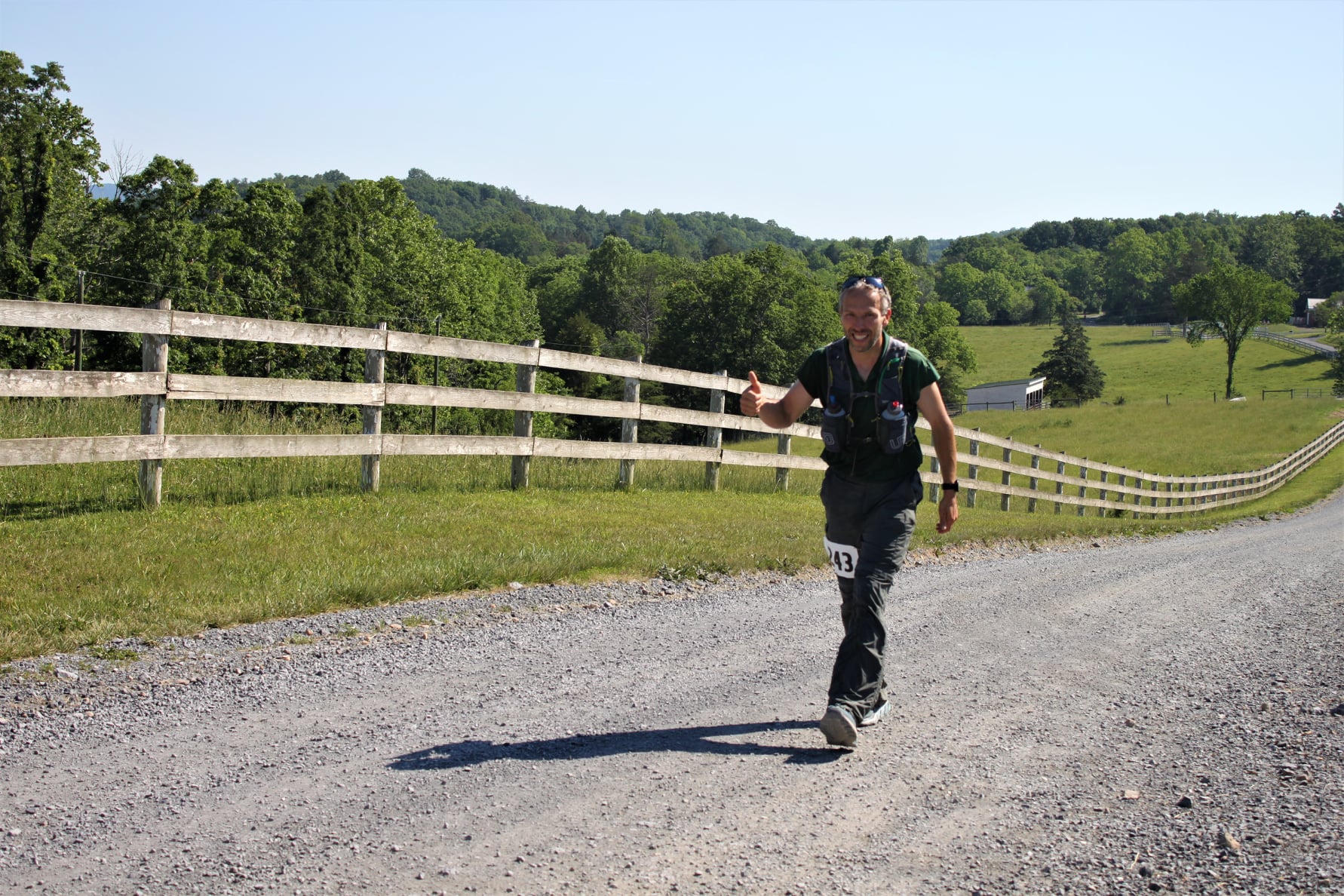Michael Yoder running along a gravel road near creekside.